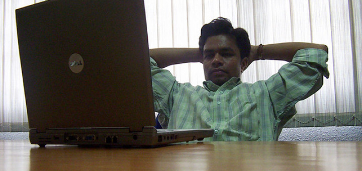 A man watching a laptop computer