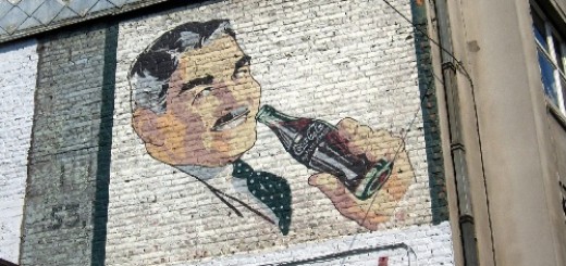 An old-fashioned Coke advertisement no the side of a building