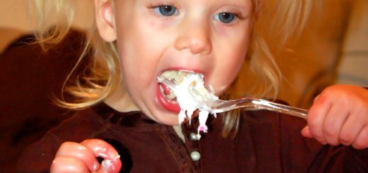 Picture of a child eating something unidentifiable (ice cream?)