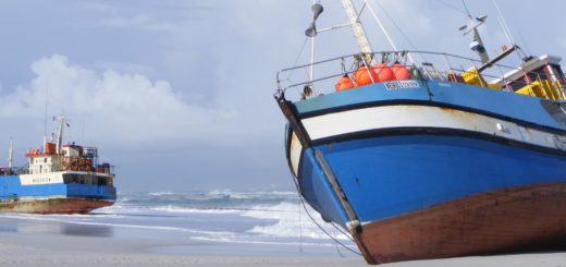 Two shipwrecked fishing boats on a beach